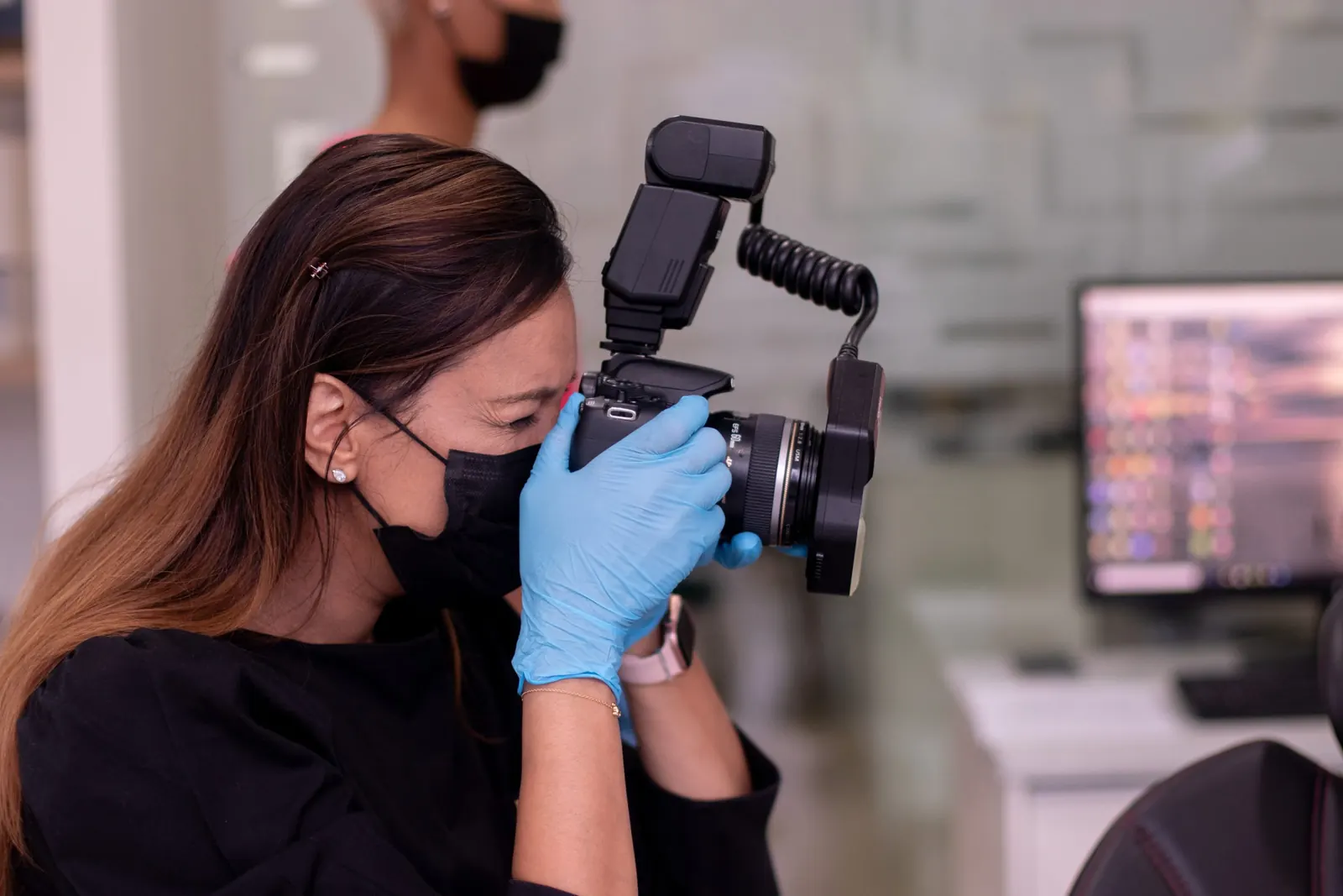 Dentist taking clinical photos with a macro camera and ring flash