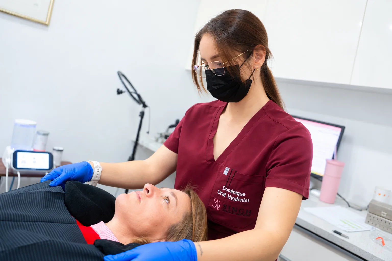 Oral hygienist Dominique Swanepoel settling a patient into the chair
