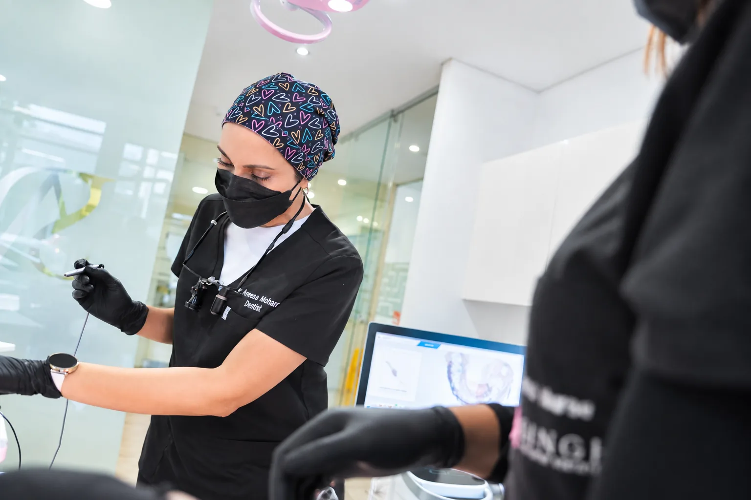 Dr Aneesa Mohamed preparing instruments beside the intraoral scanner
