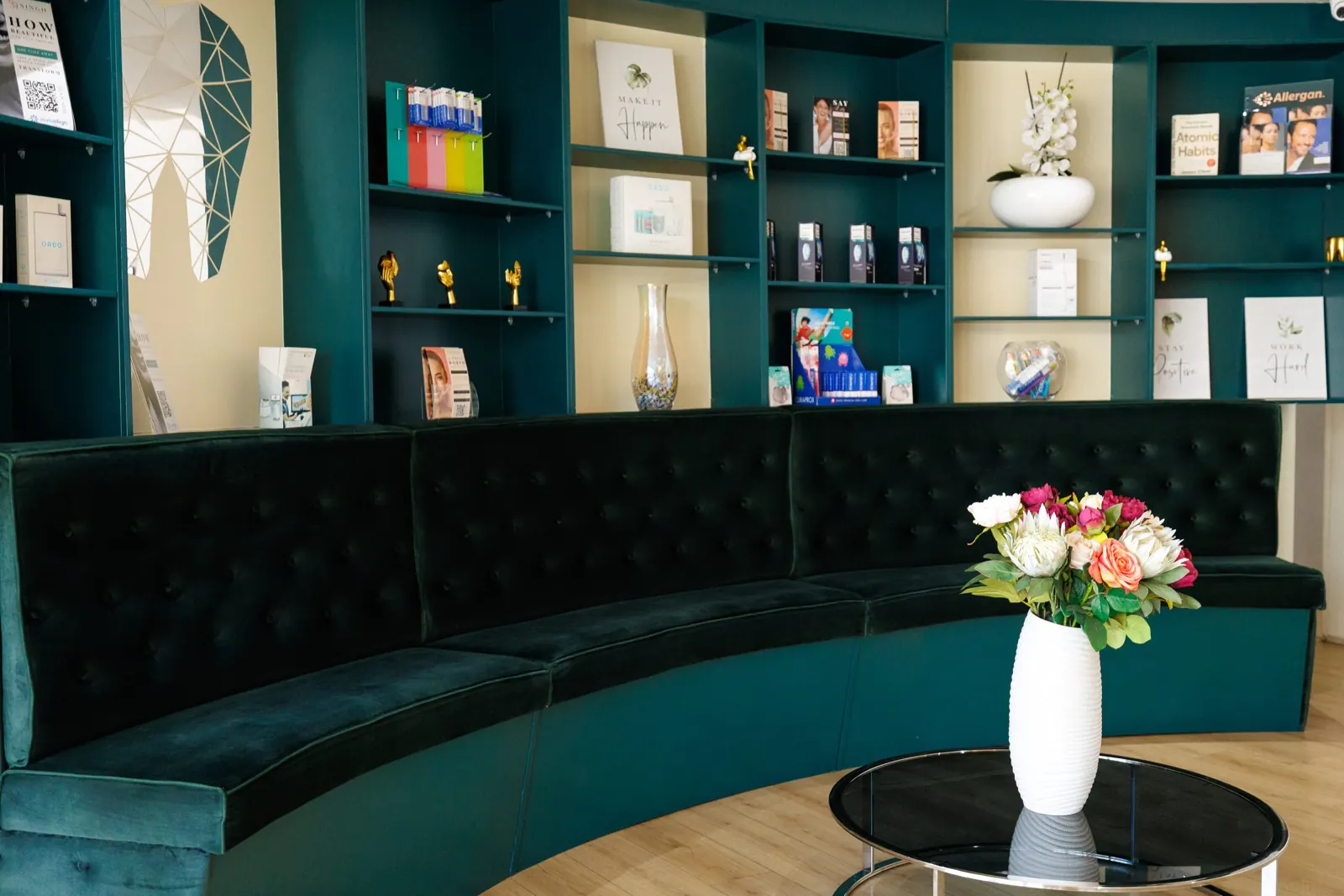 Waiting lounge with a green velvet sofa and fresh flowers